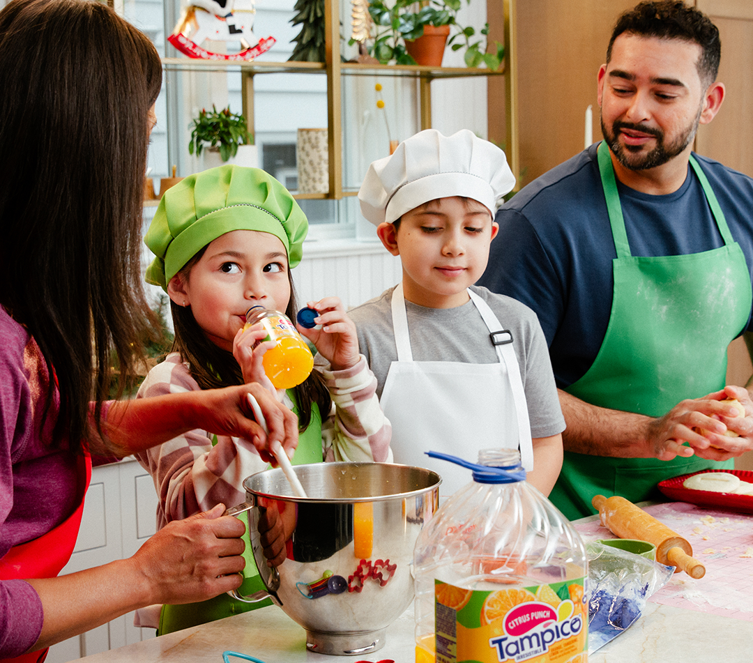 a family enjoys cooking in the kitchen