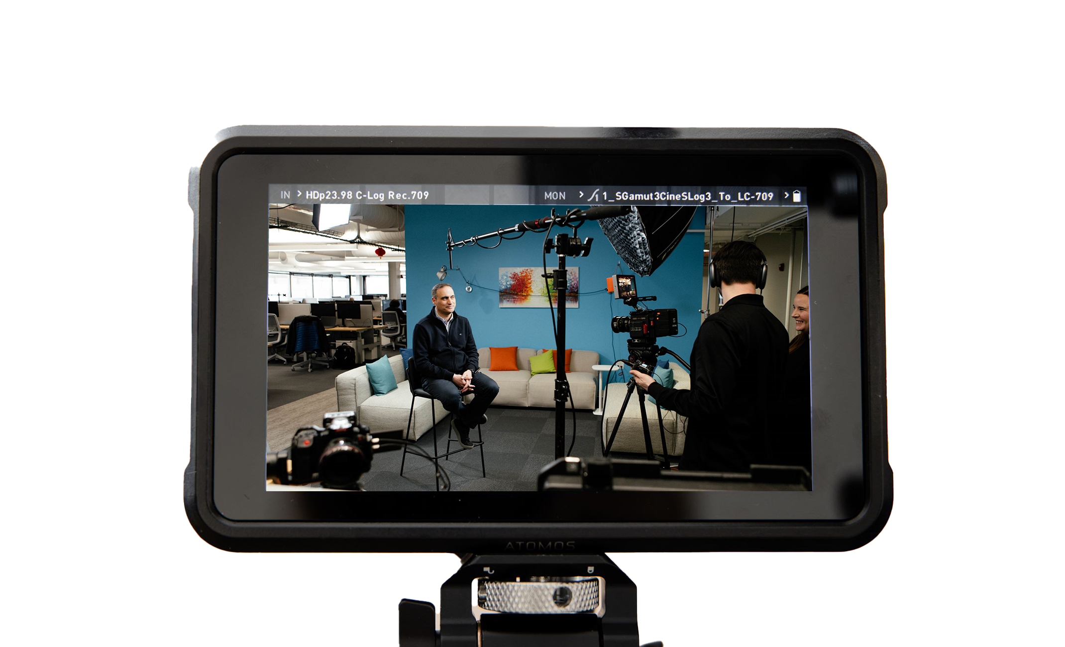 Film crew interviewing a person in a modern office