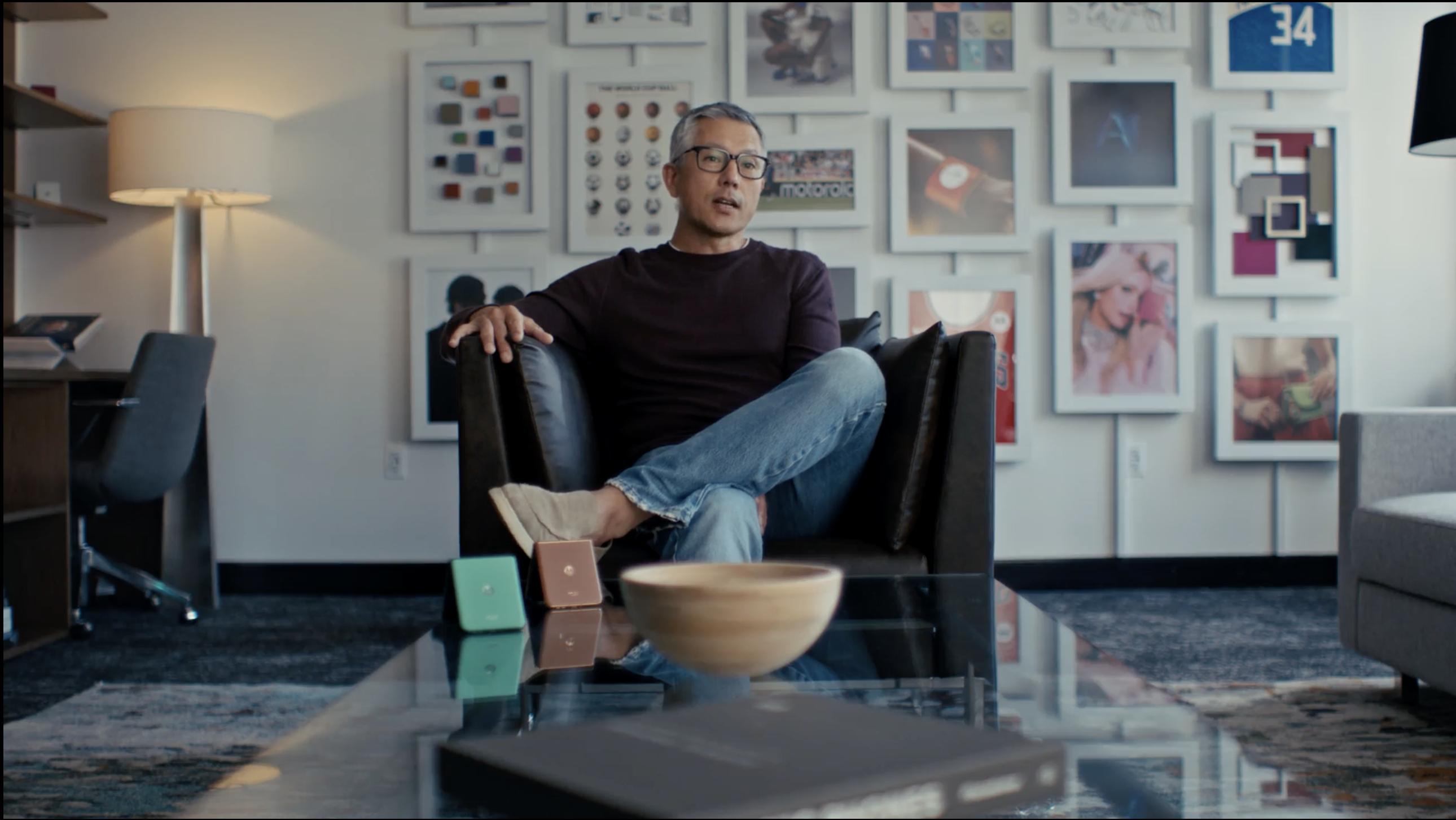 A man with glasses seated in an armchair during an interview