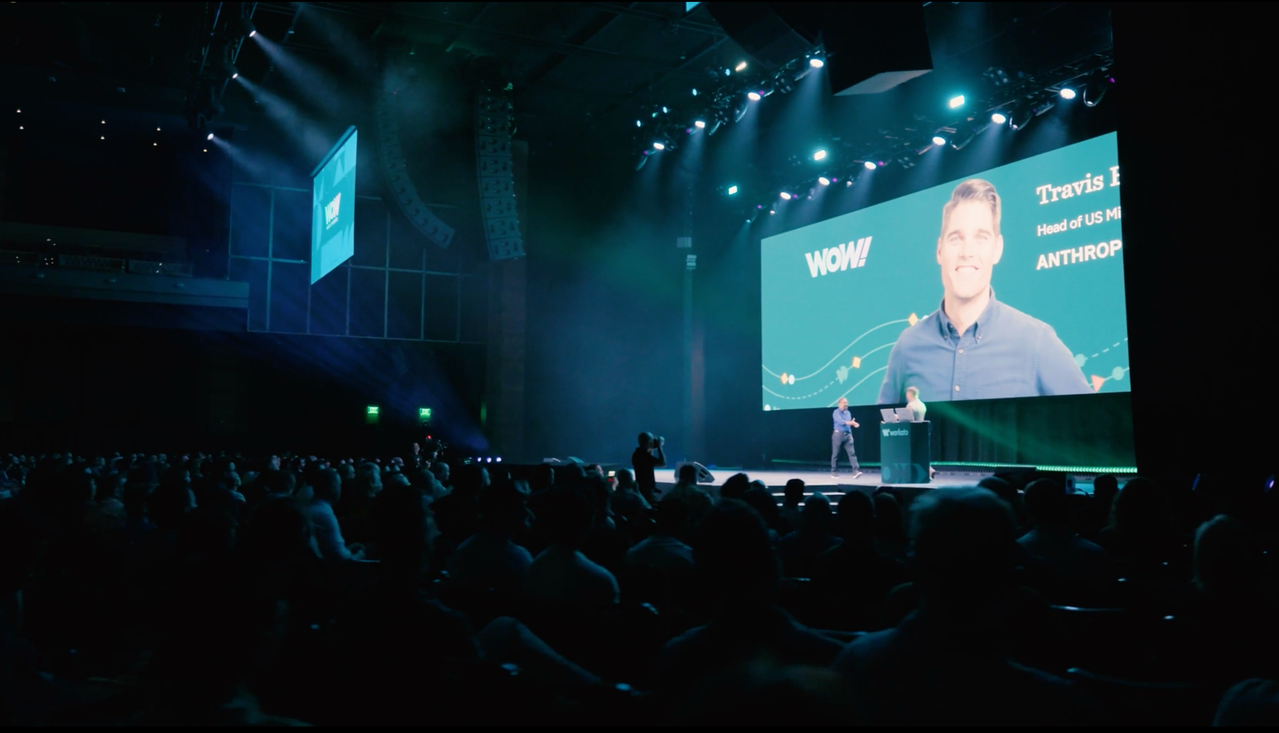 Speakers on stage at a Workato conference