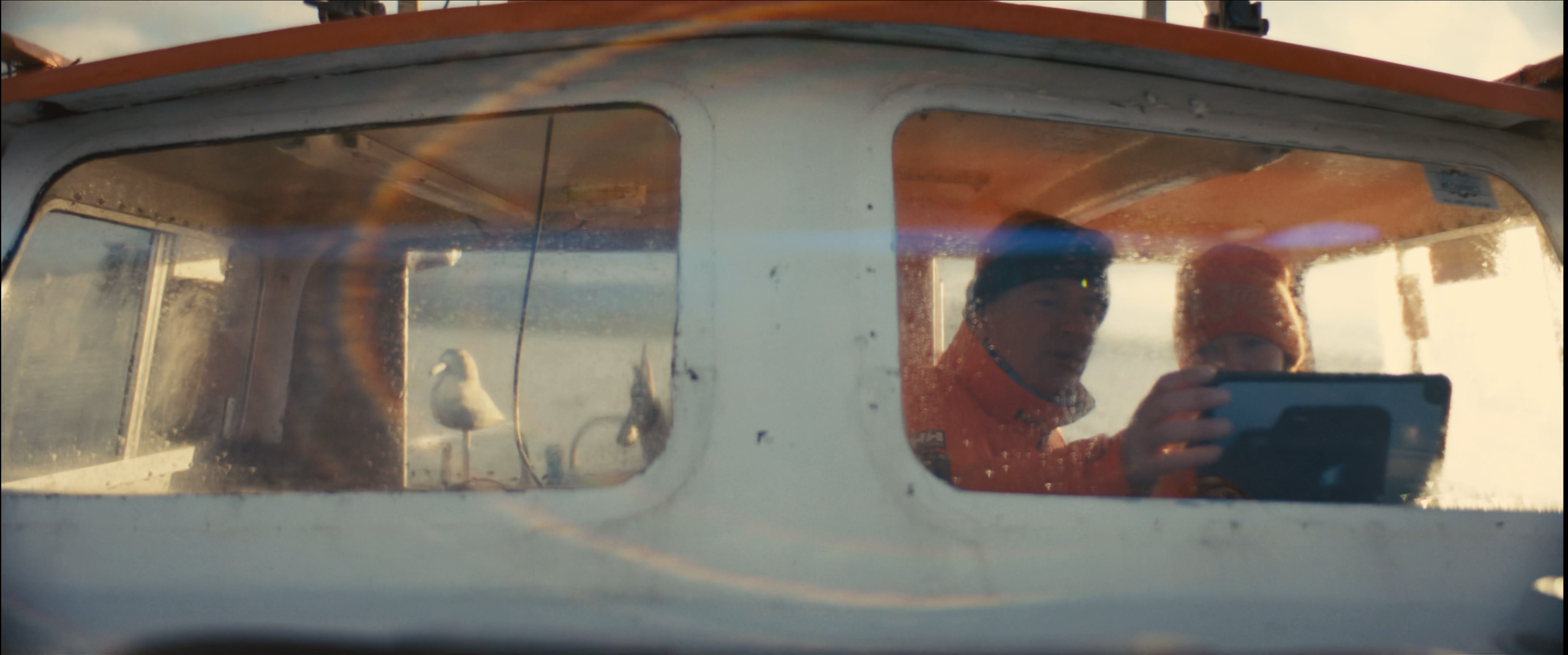 Two people collaborating aboard a boat